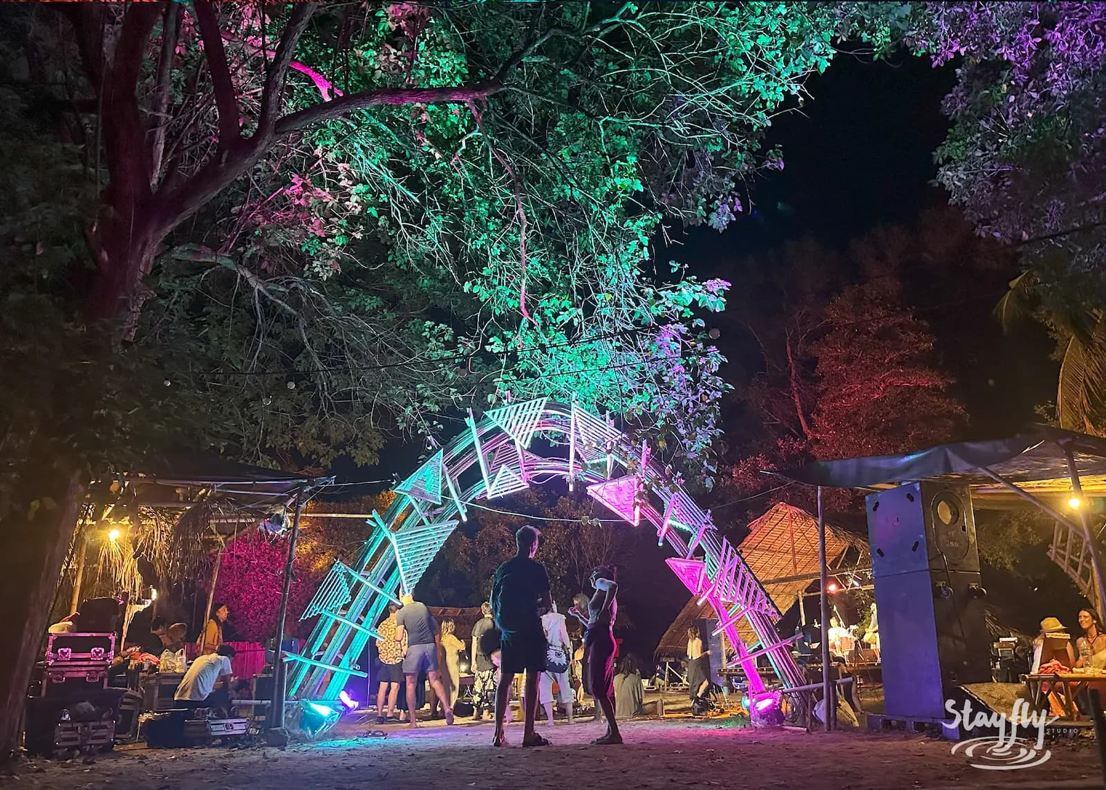 Illuminated bamboo bridge arch at night.