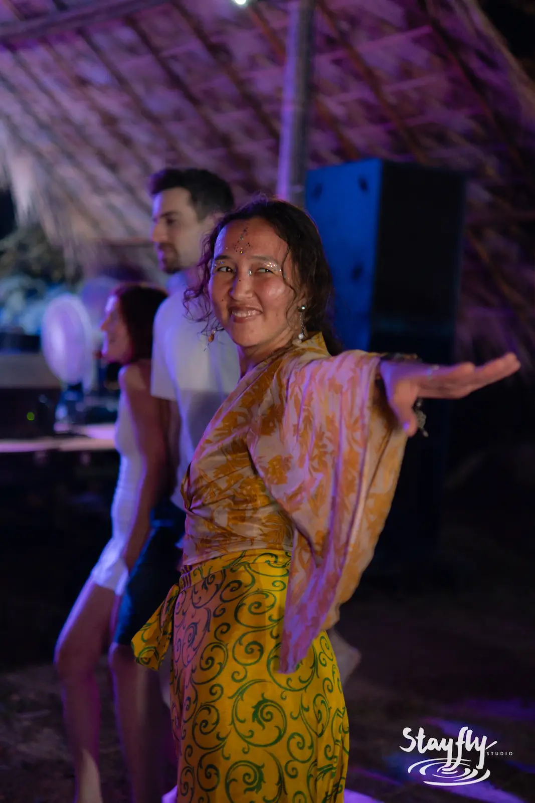 Woman dances joyfully at night event.
