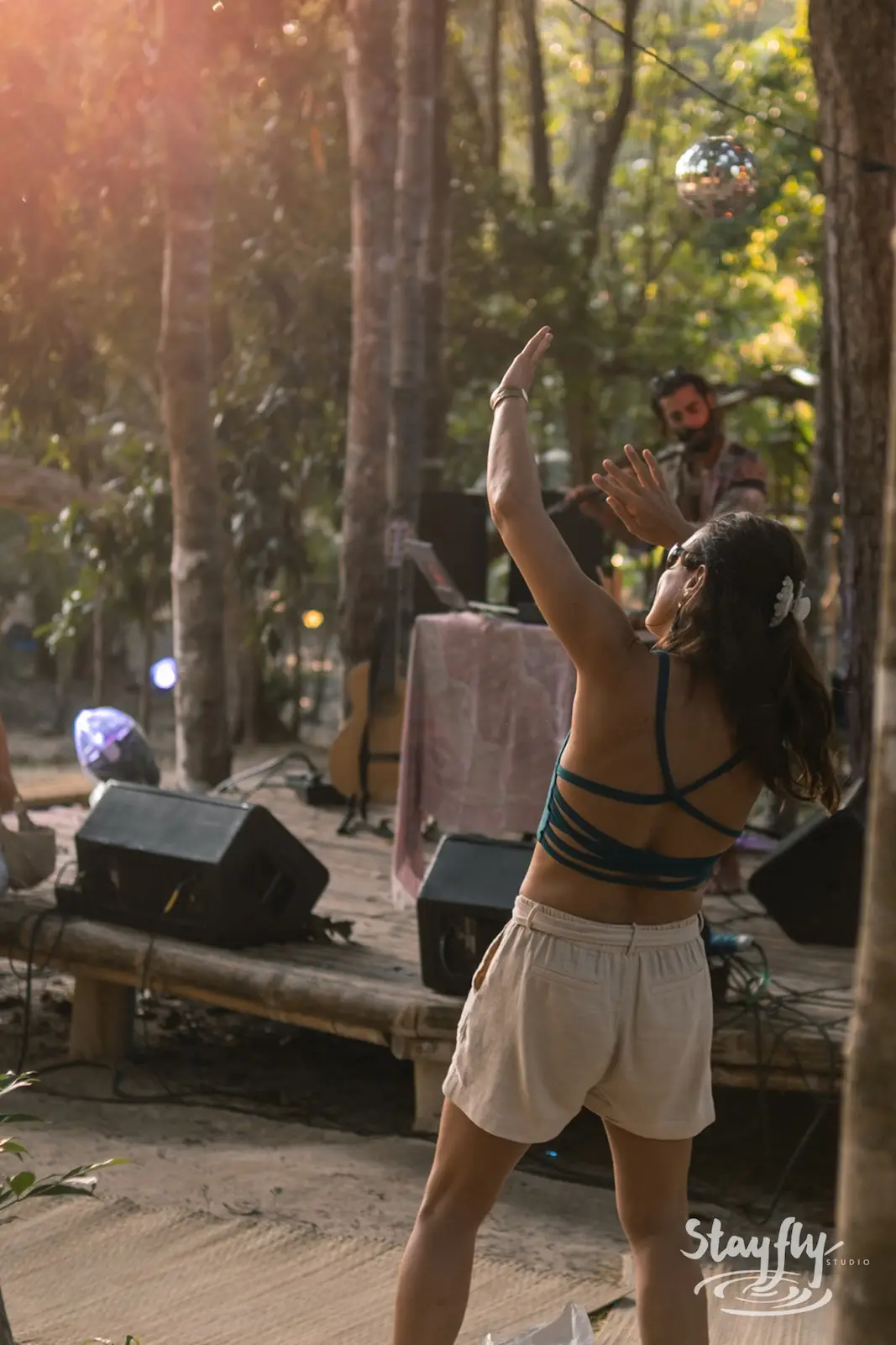 Woman dances at forest ecstatic dance session.