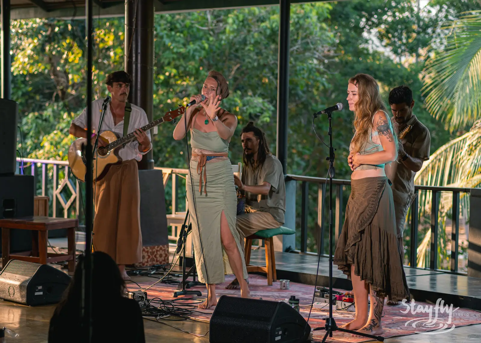 Band performs live on covered outdoor stage.