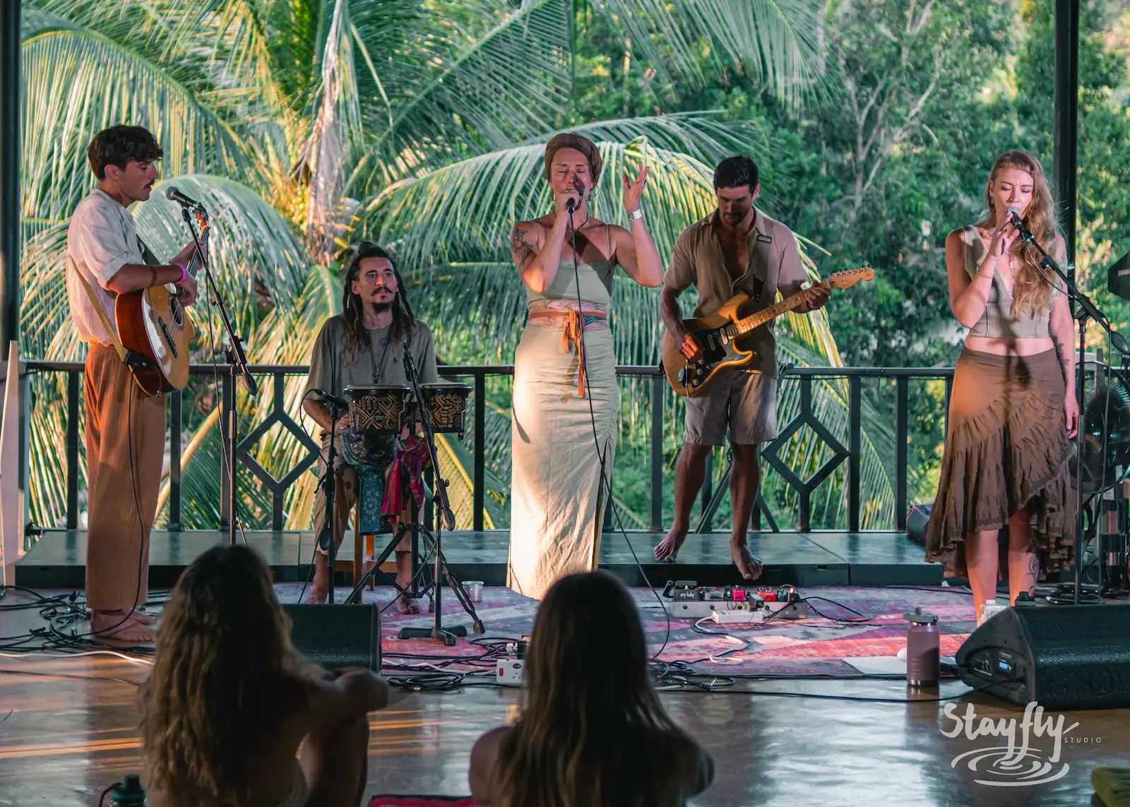 Band performs on daytime forest stage.