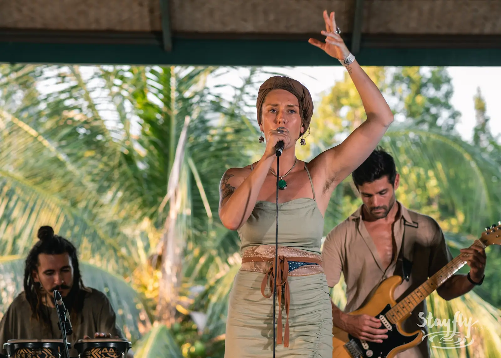 Woman singing with band on stage.