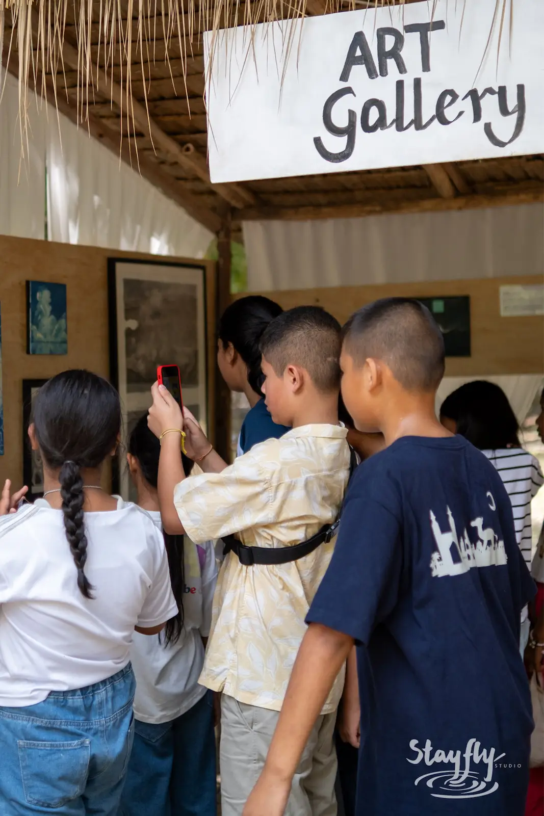 Kids gather outside the Art Gallery sign.