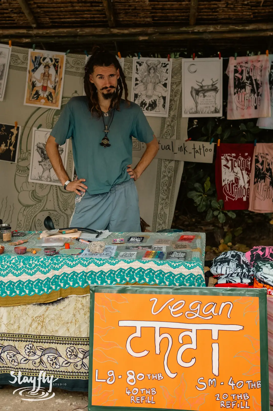 Vendor standing behind a vegan chai stall.