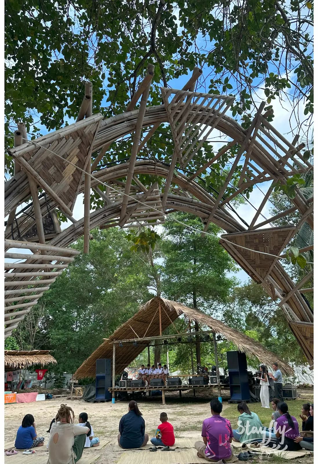 Bamboo dome structure with crowd watching below.
