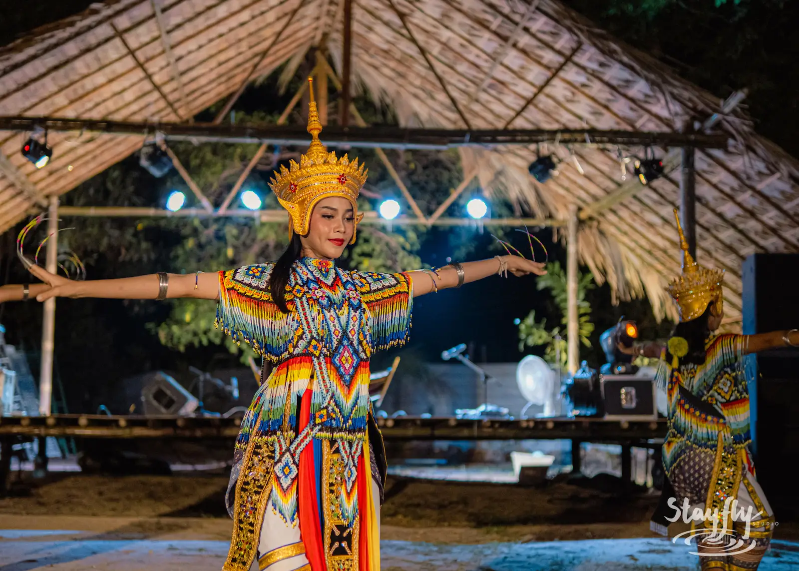 Solo dancer performs in gold traditional costume.