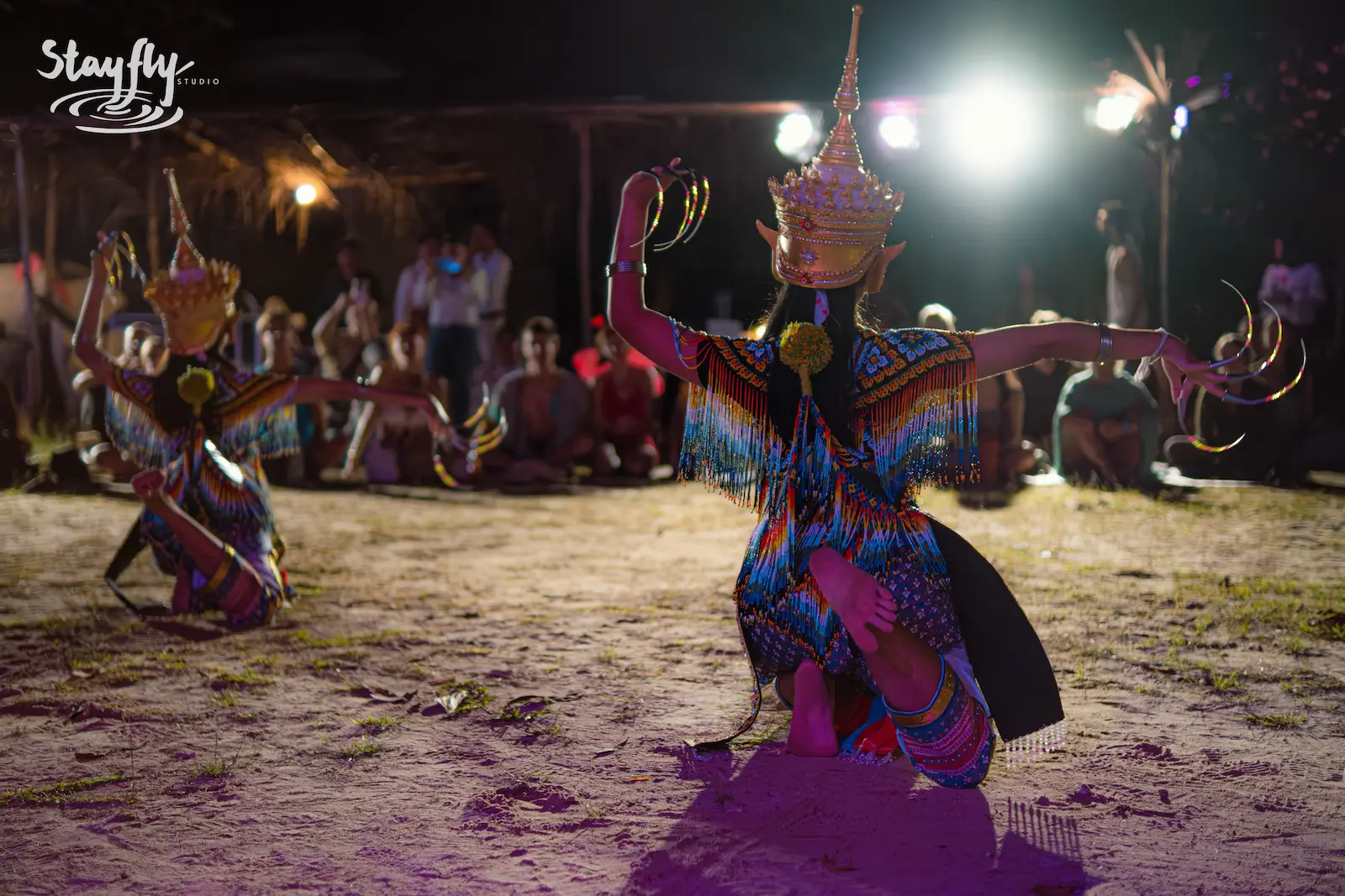 Two masked dancers with gold clawed gloves.