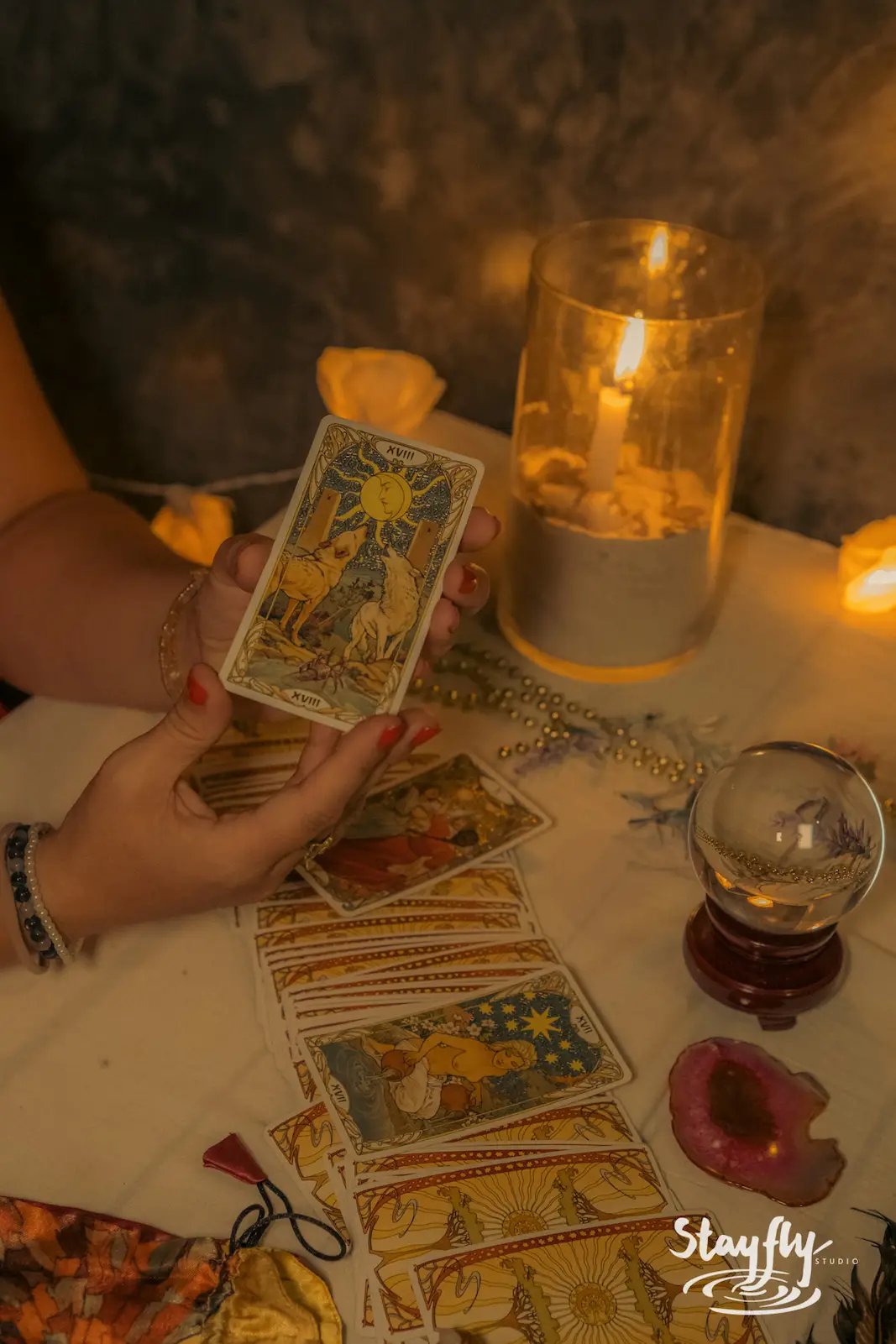 Tarot card reading with candle and crystal ball.