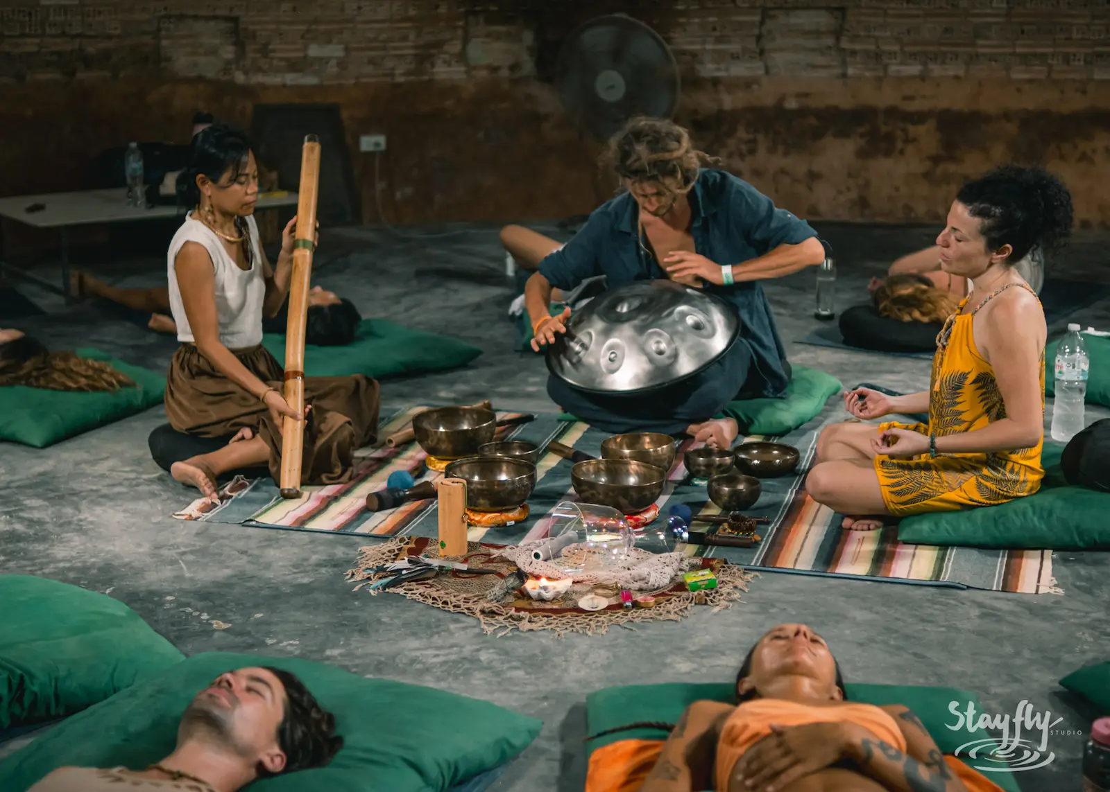 Sound healing circle with singing bowls and handpan.