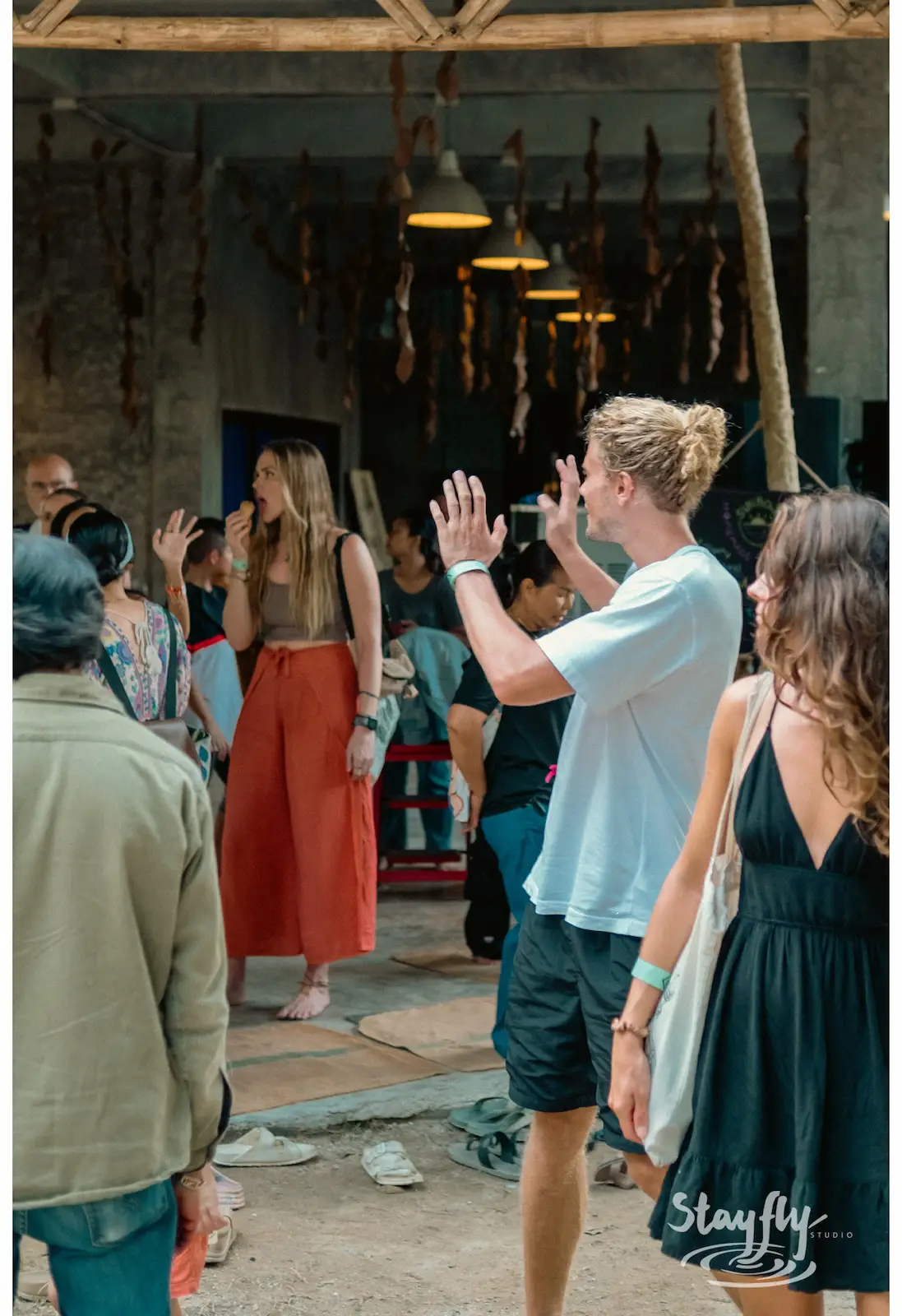 Crowd high-fiving inside an industrial building.