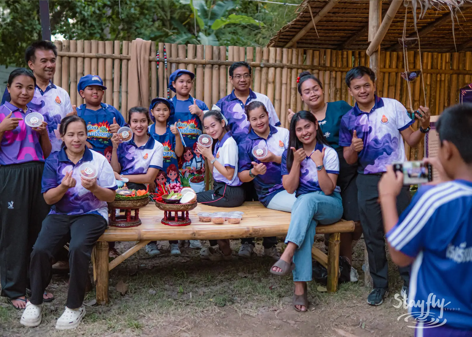 Staff group photo in matching purple shirts.