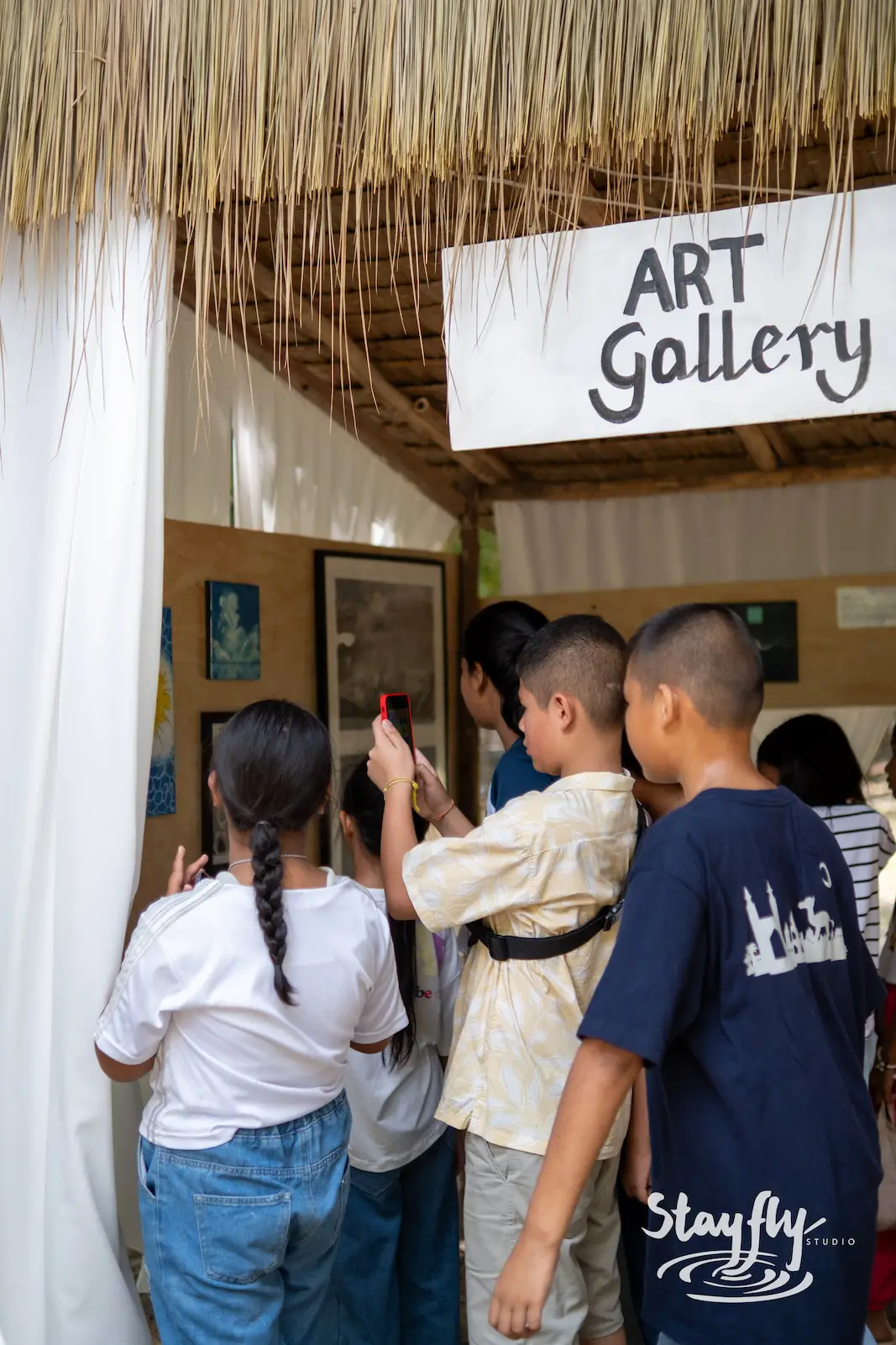 Children at Art Gallery entrance, one photographing.
