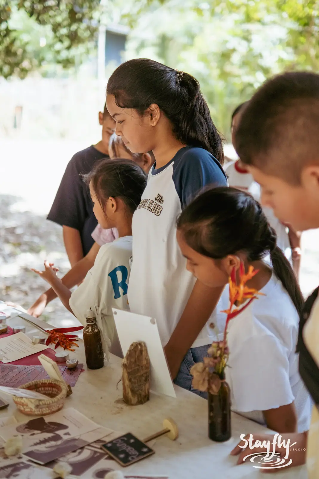 Children at a natural dye craft table.
