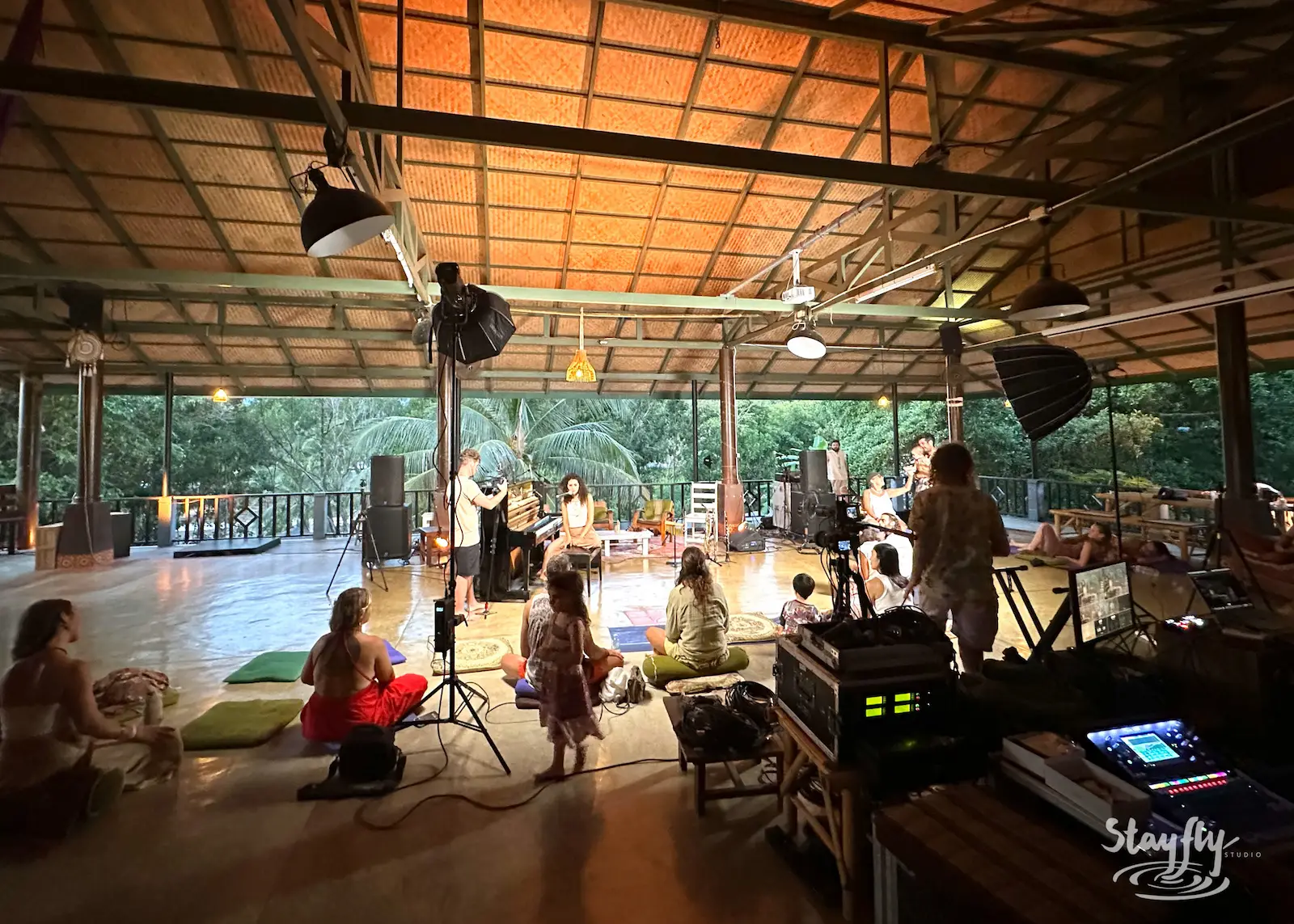 Film crew records daytime performance under open roof.