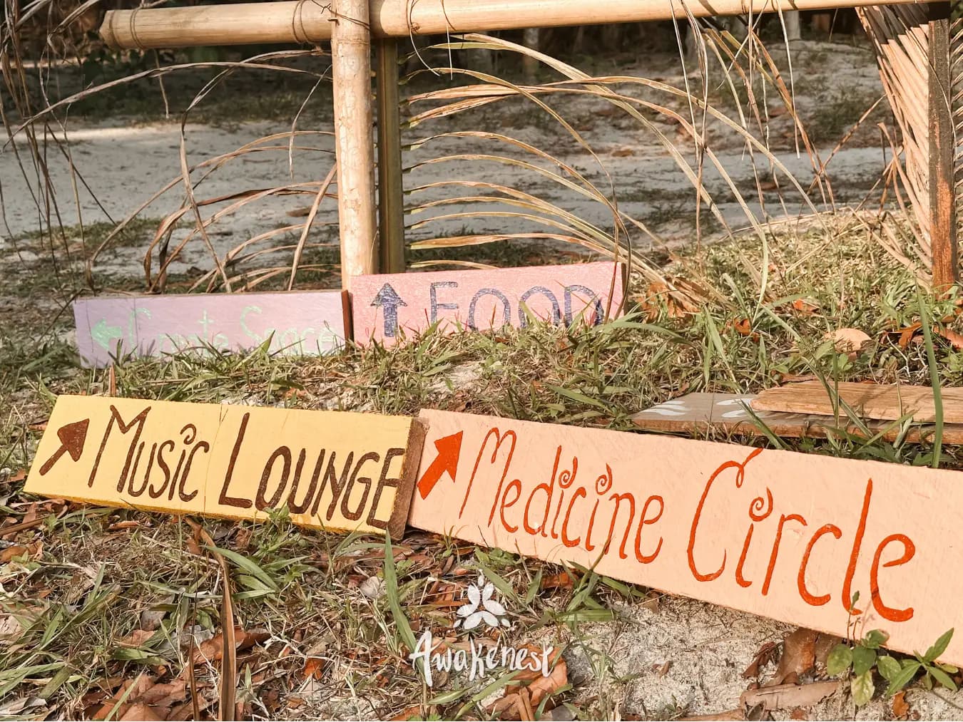 Hand-painted wayfinding signs for festival areas.