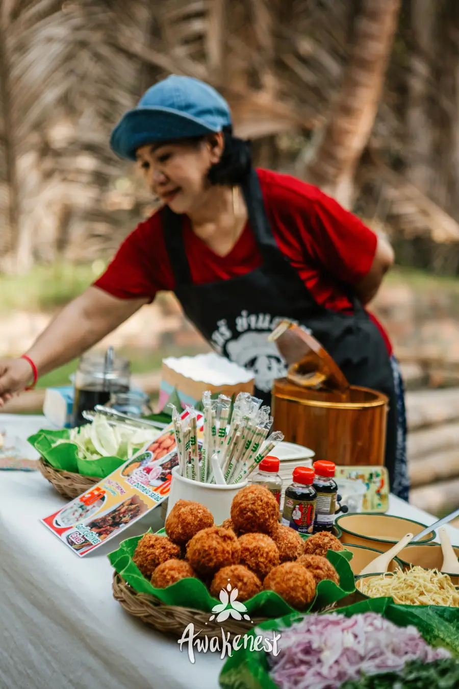 Vendor serving fried snacks at food stall.