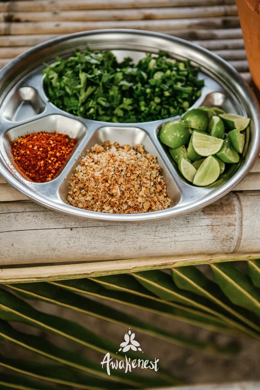 Plate of herbs, chili flakes, and lime.