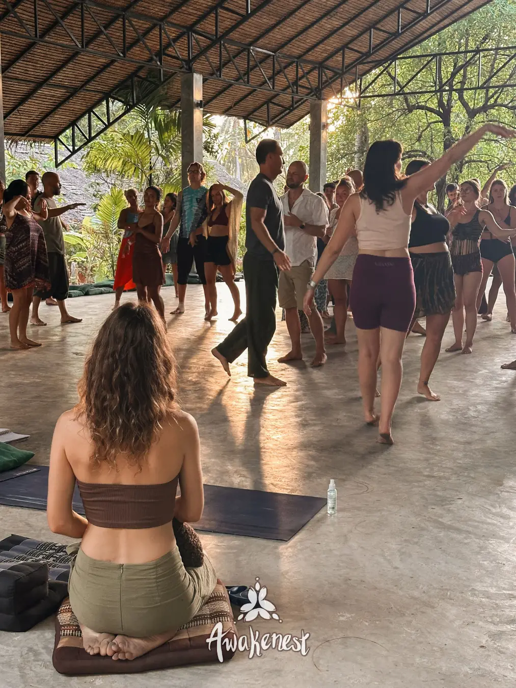 People dancing together in open pavilion.