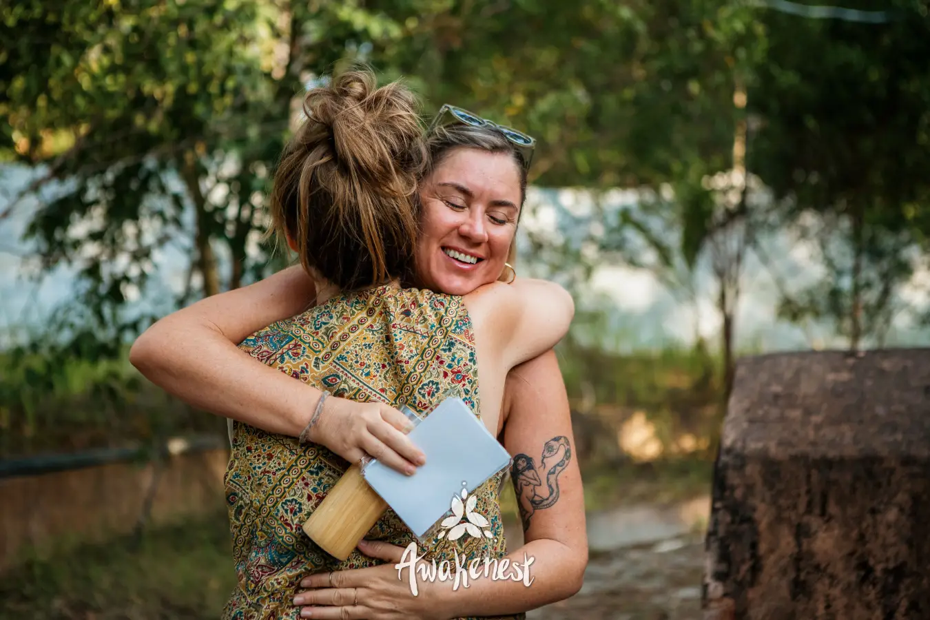 Two women share a warm embrace.