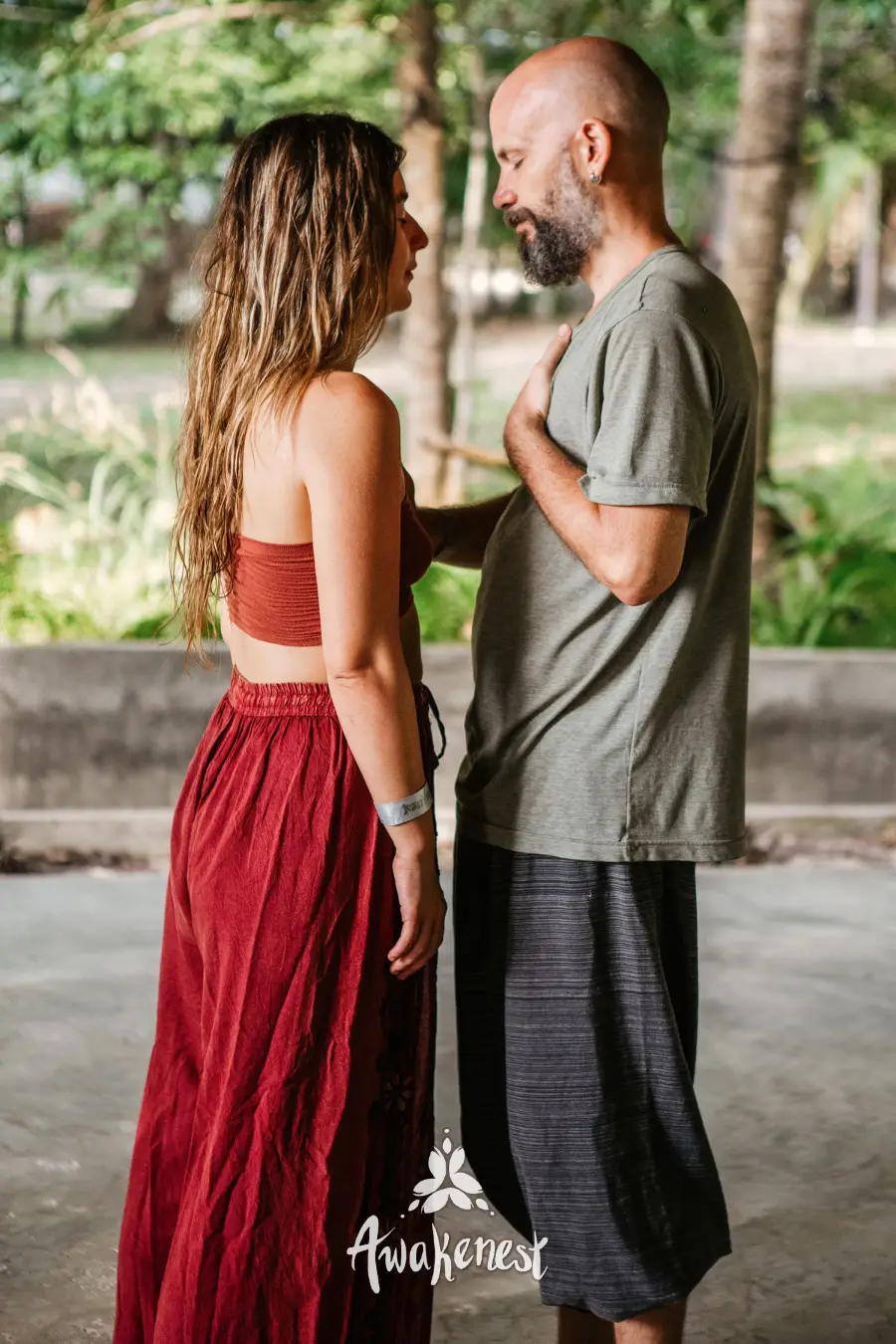 Couple facing each other in courtyard.