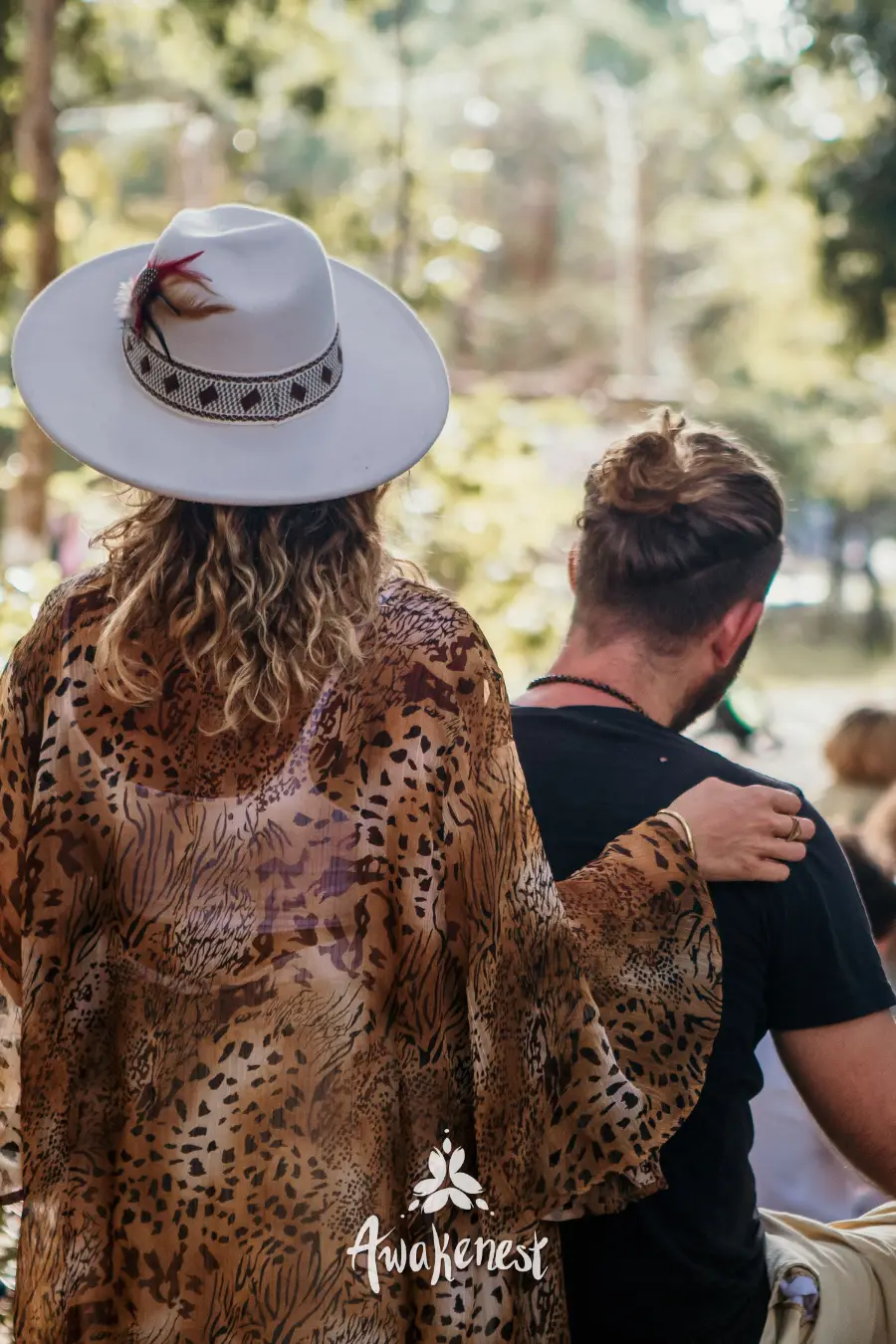 Couple in wide-brim hat and leopard shawl.