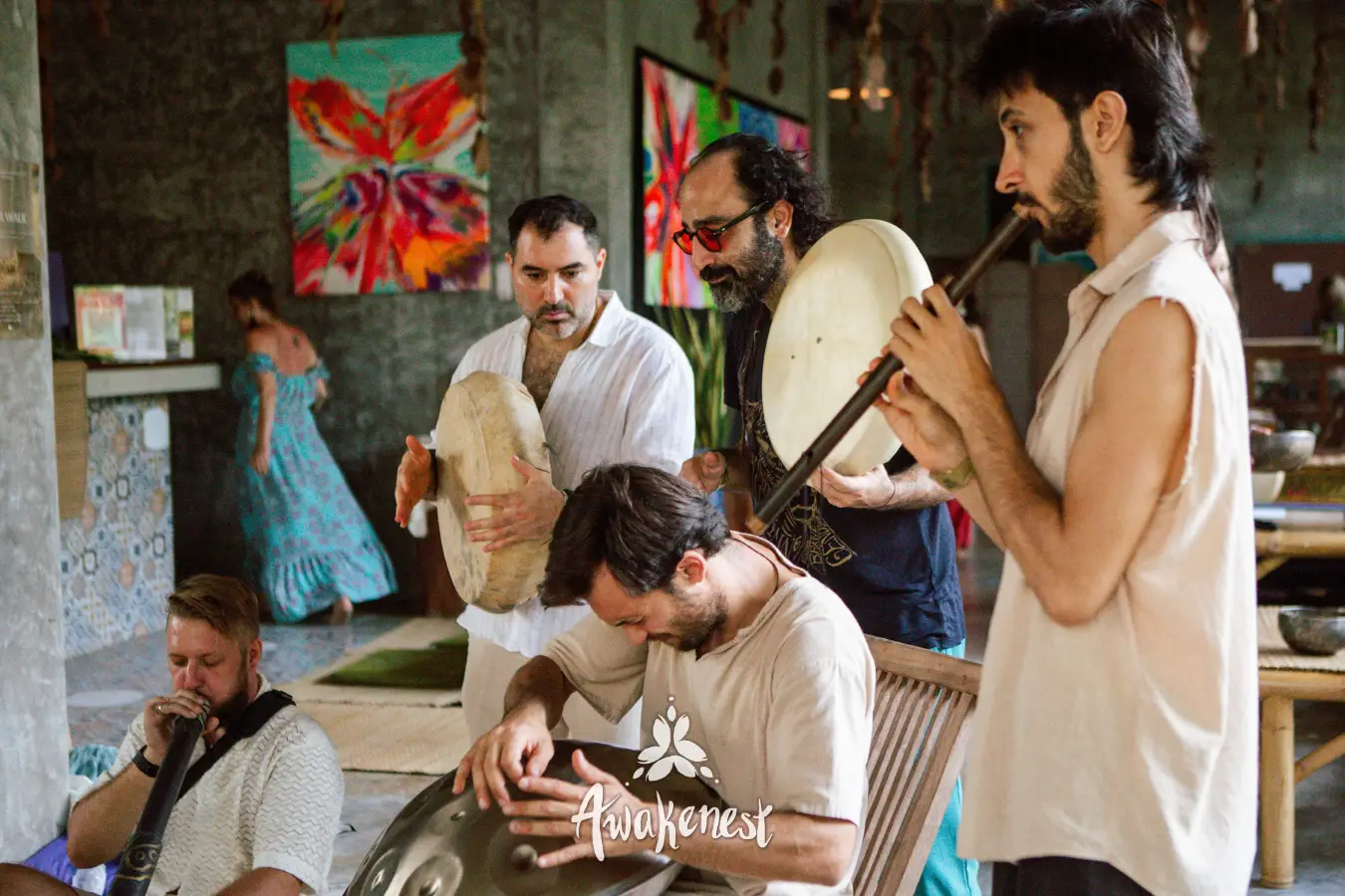 Musicians play frame drum and flute together.