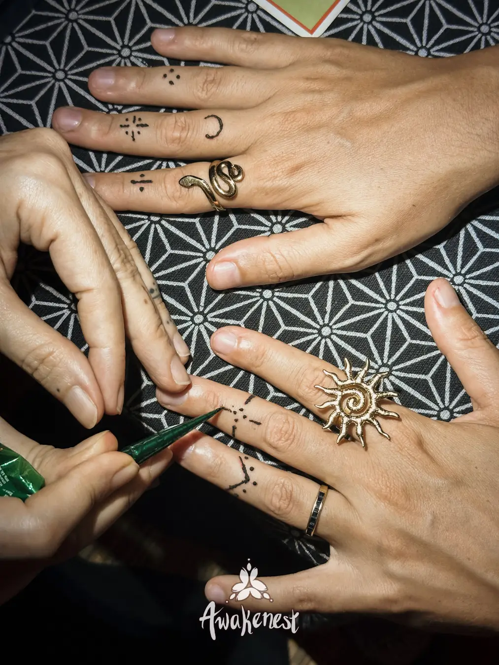 Close-up of hands receiving henna art.