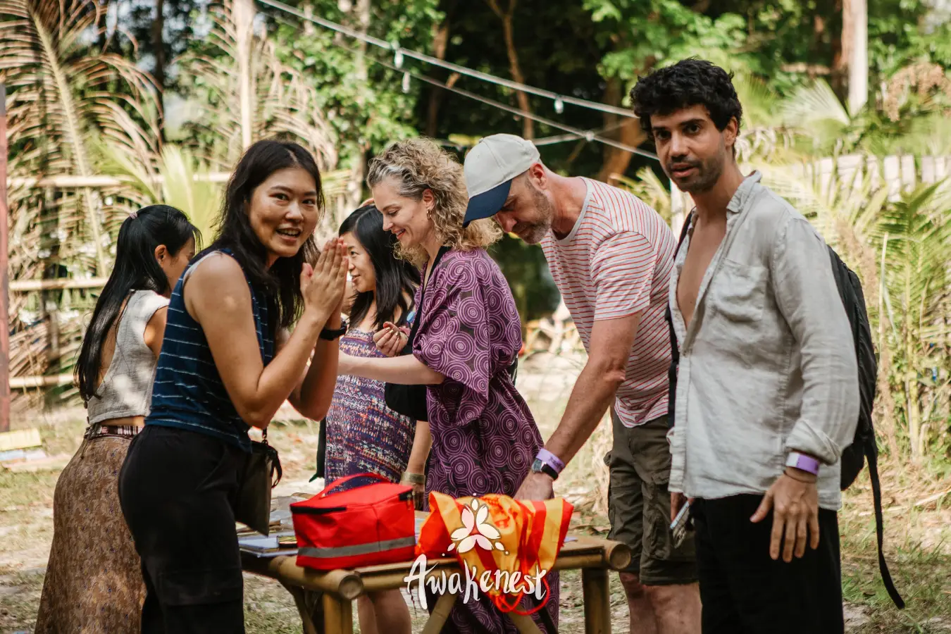 Group laughs gathered around a market table.