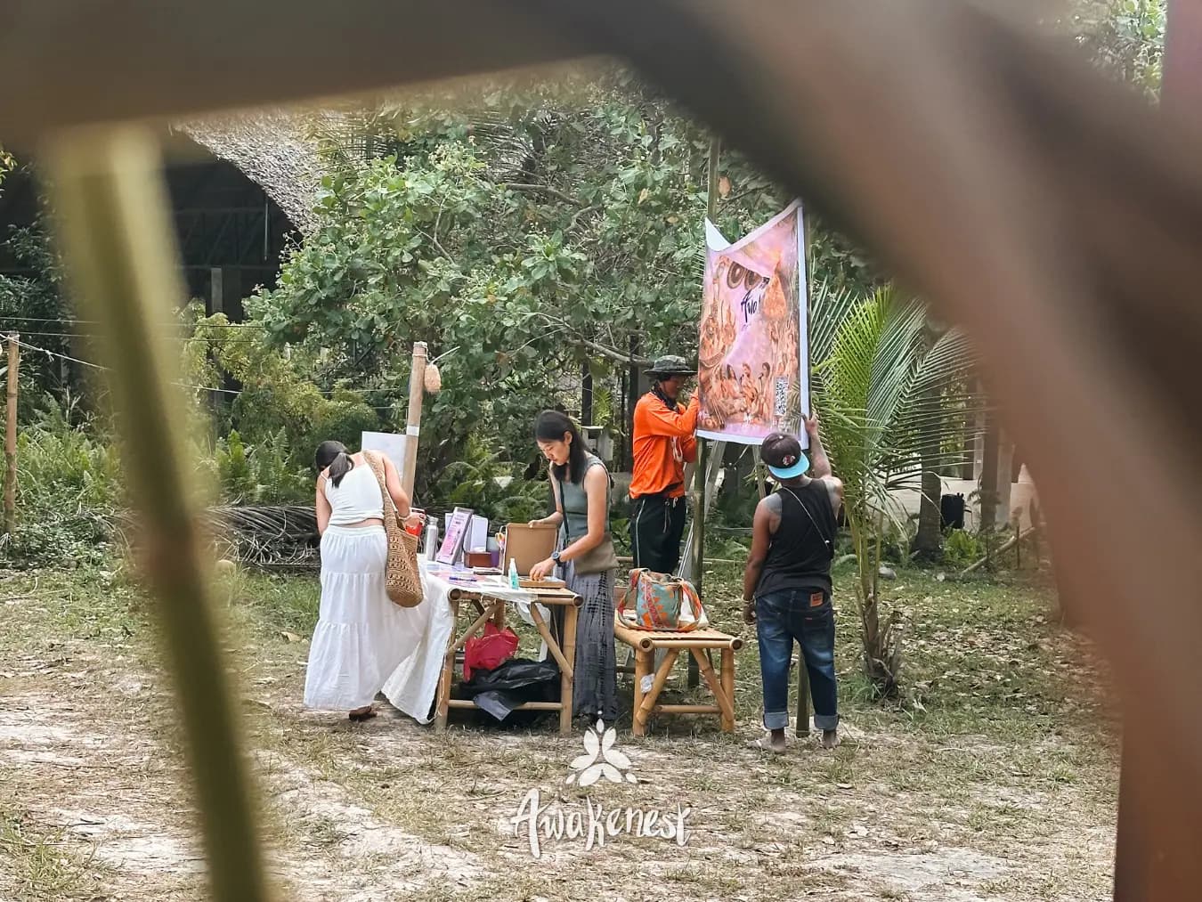 Vendors setting up art stall outdoors.