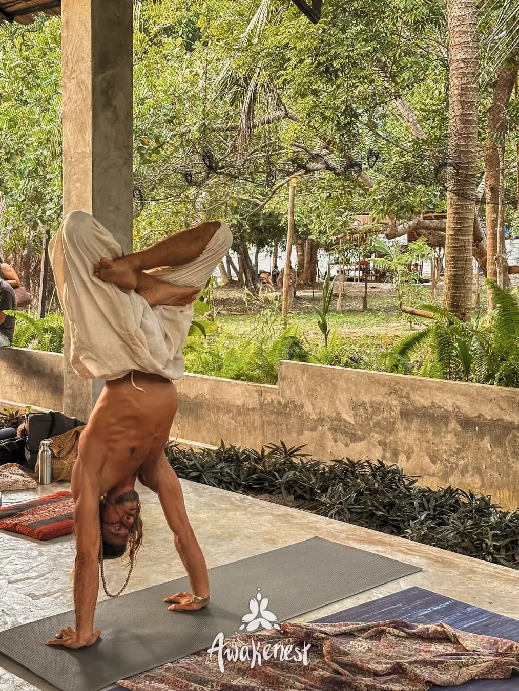 Person doing yoga headstand outdoors.