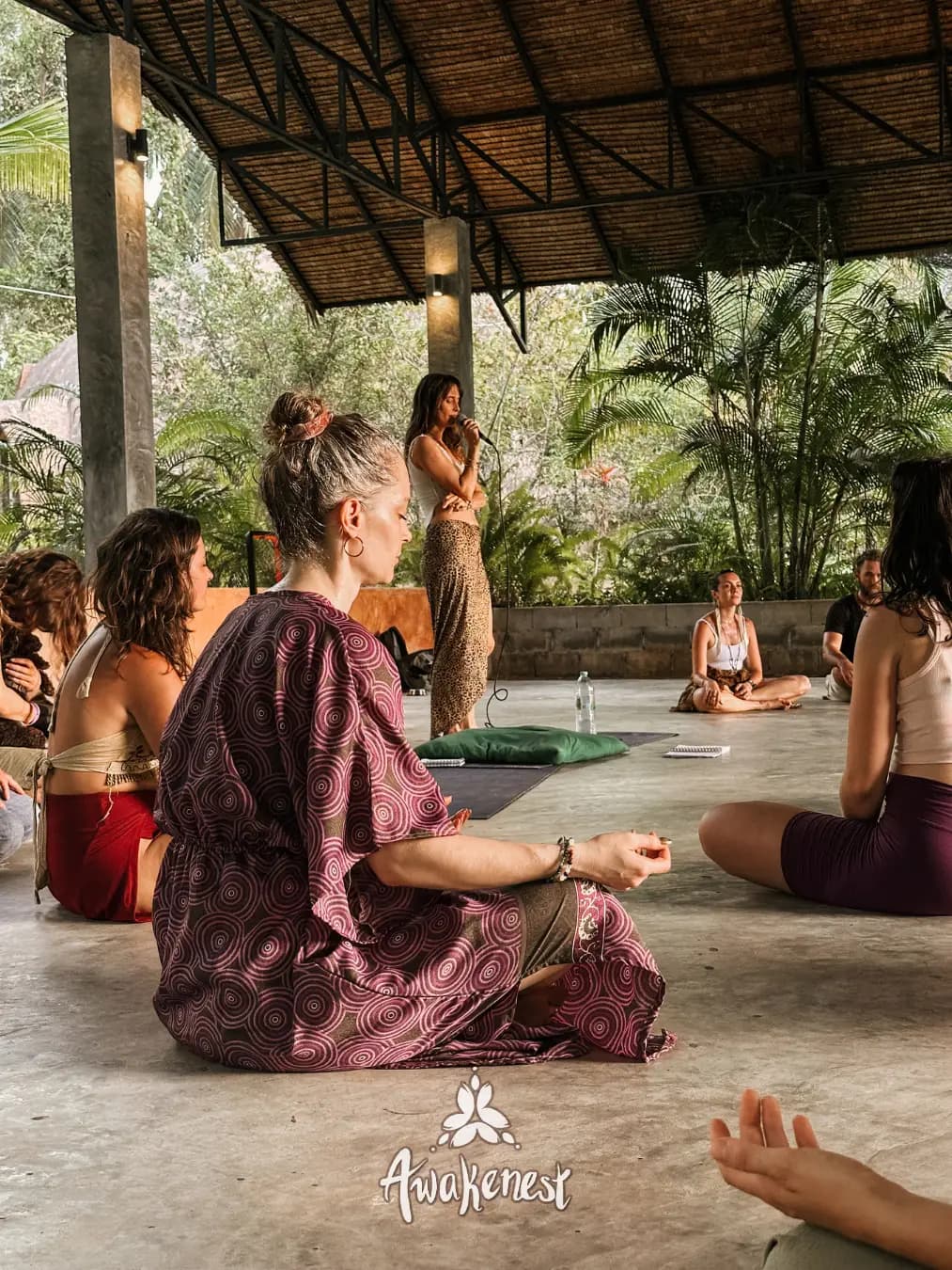 Meditation circle seated under open pavilion.