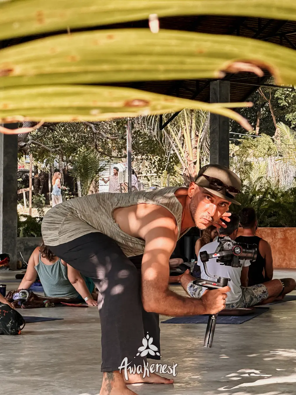 Photographer films yoga class with camera gimbal.