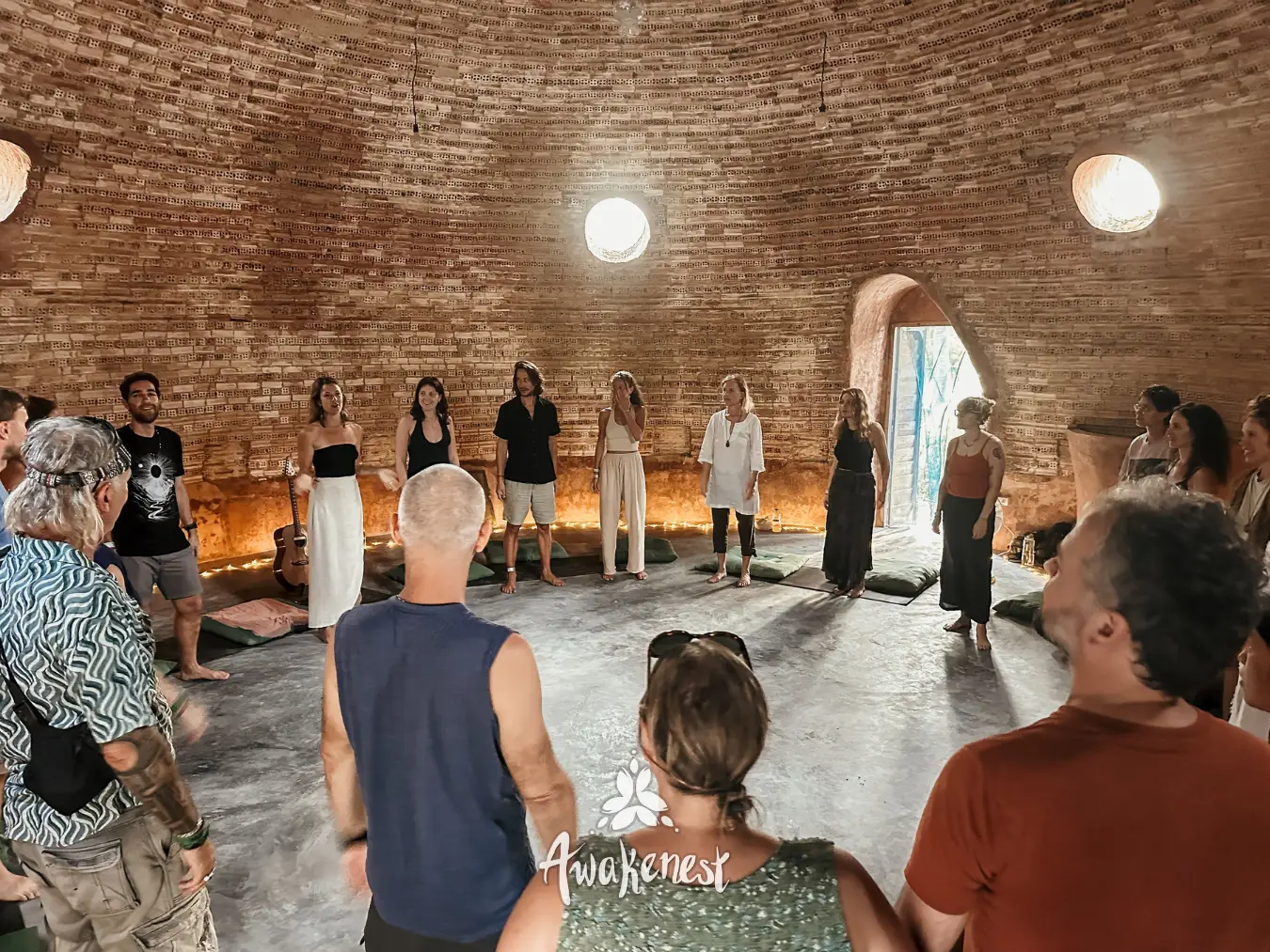 Circle ceremony inside brick domed structure.