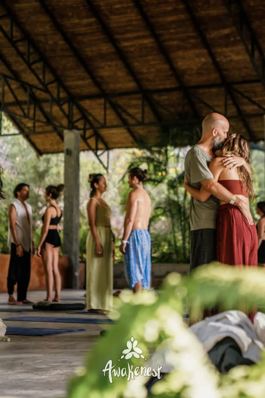 Partner embrace exercise during yoga session.
