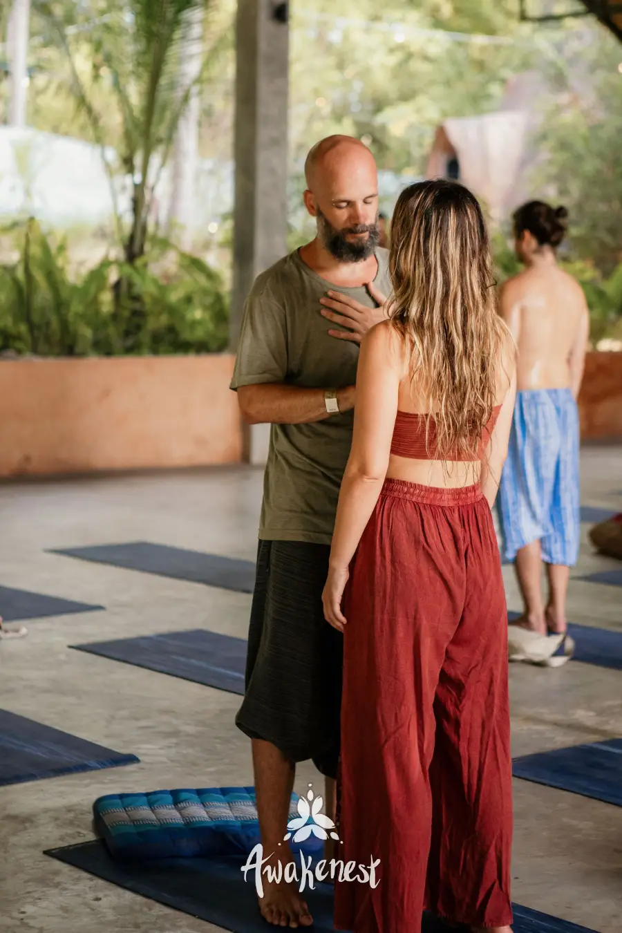 Partner exercise, hand on chest, yoga hall.