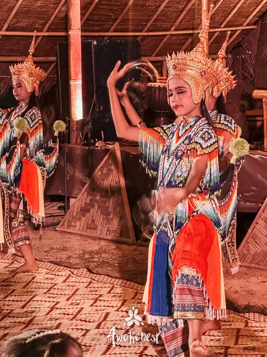 Thai traditional dancers in ornate costume headdress.