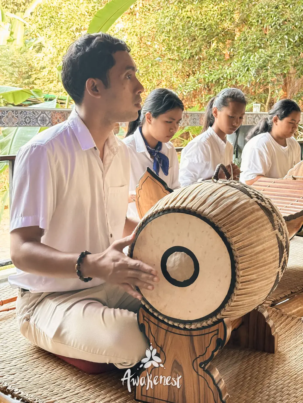 School children playing traditional Thai drum together.
