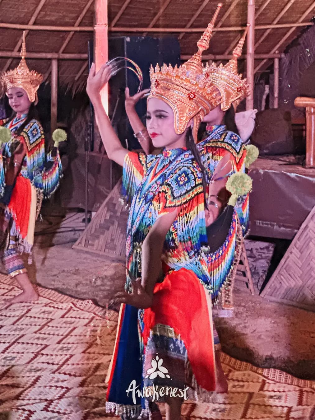 Thai dancers in costume performing on stage.