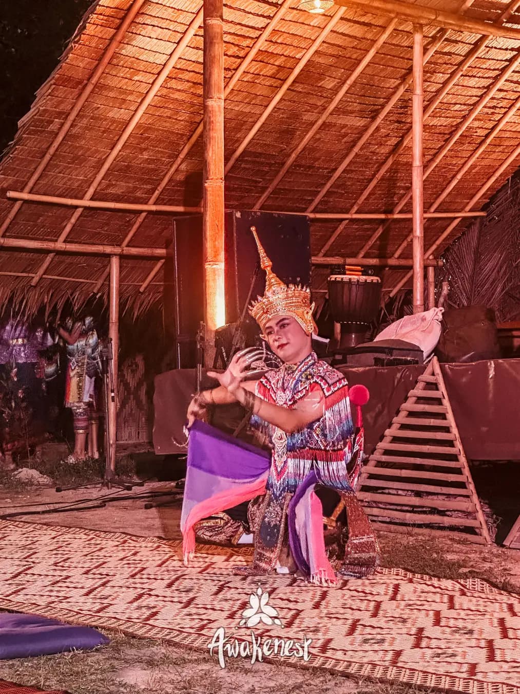 Solo Thai dancer performing in costume at night.