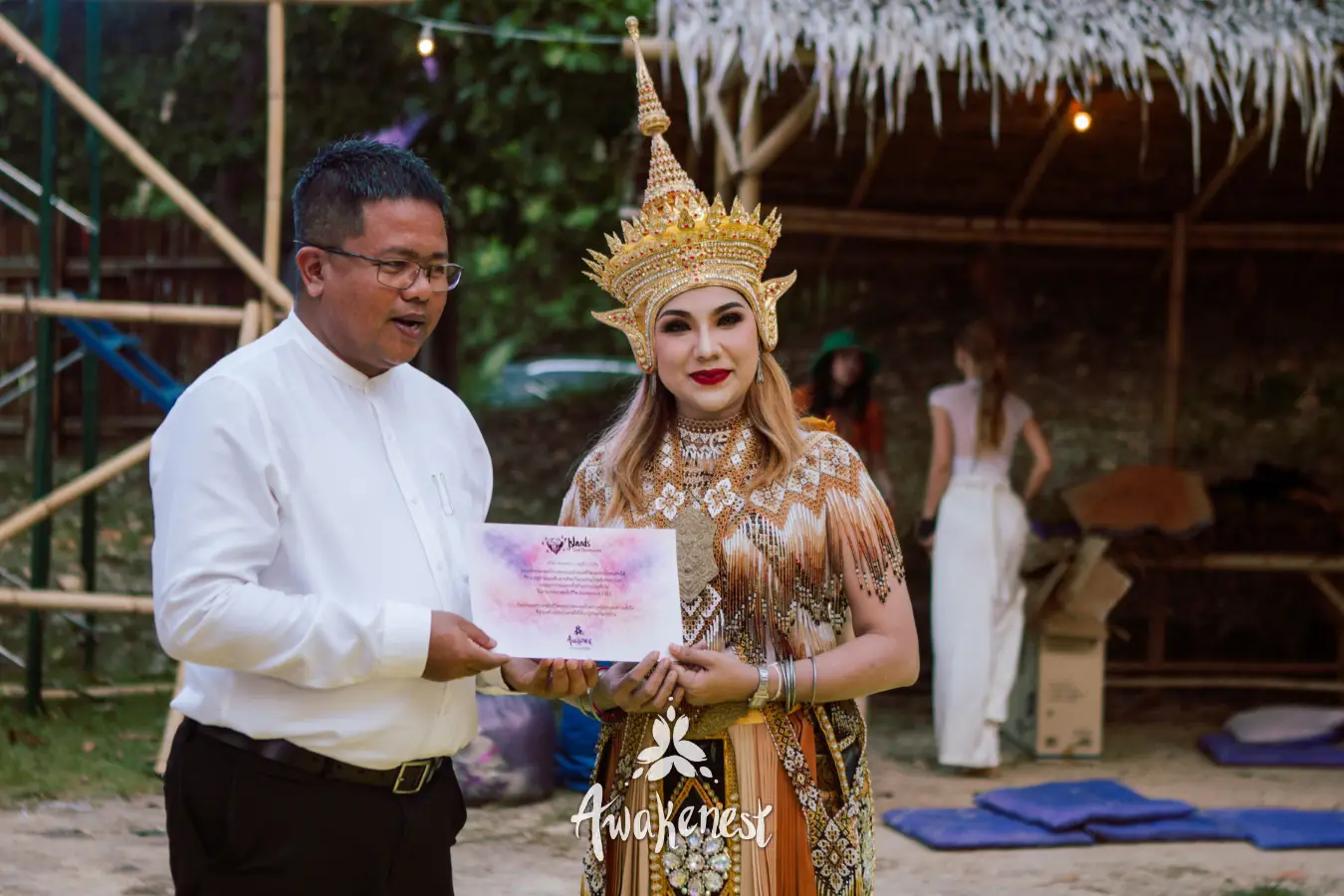 Man presents certificate to costumed performer.