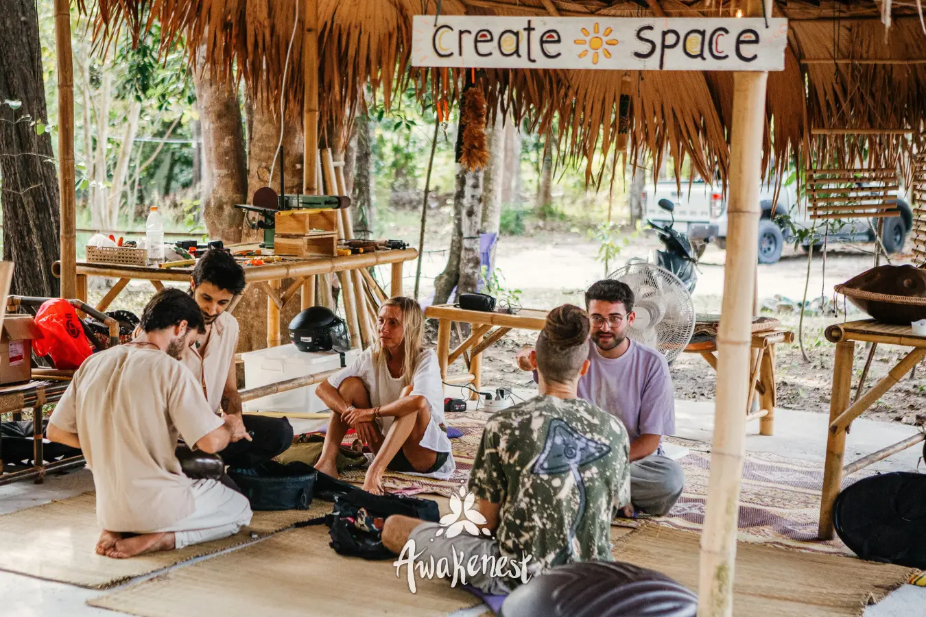Circle discussion under Create Space sign.