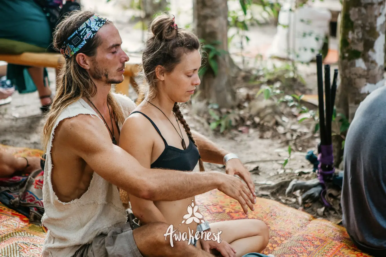 Couple sits closely in meditative touch session.