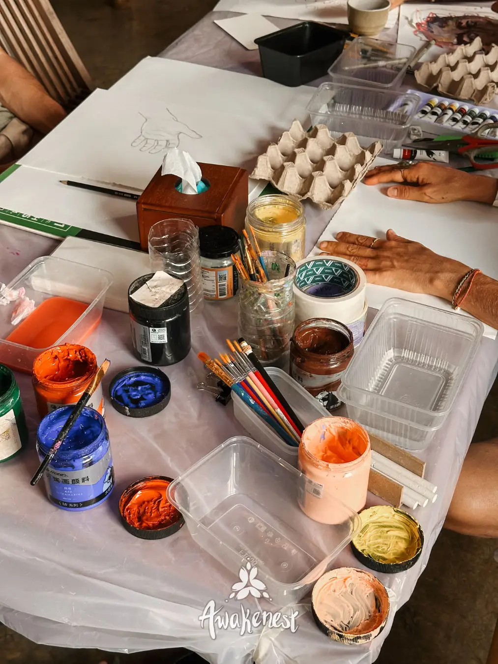 Close-up of paint pots and craft supplies.