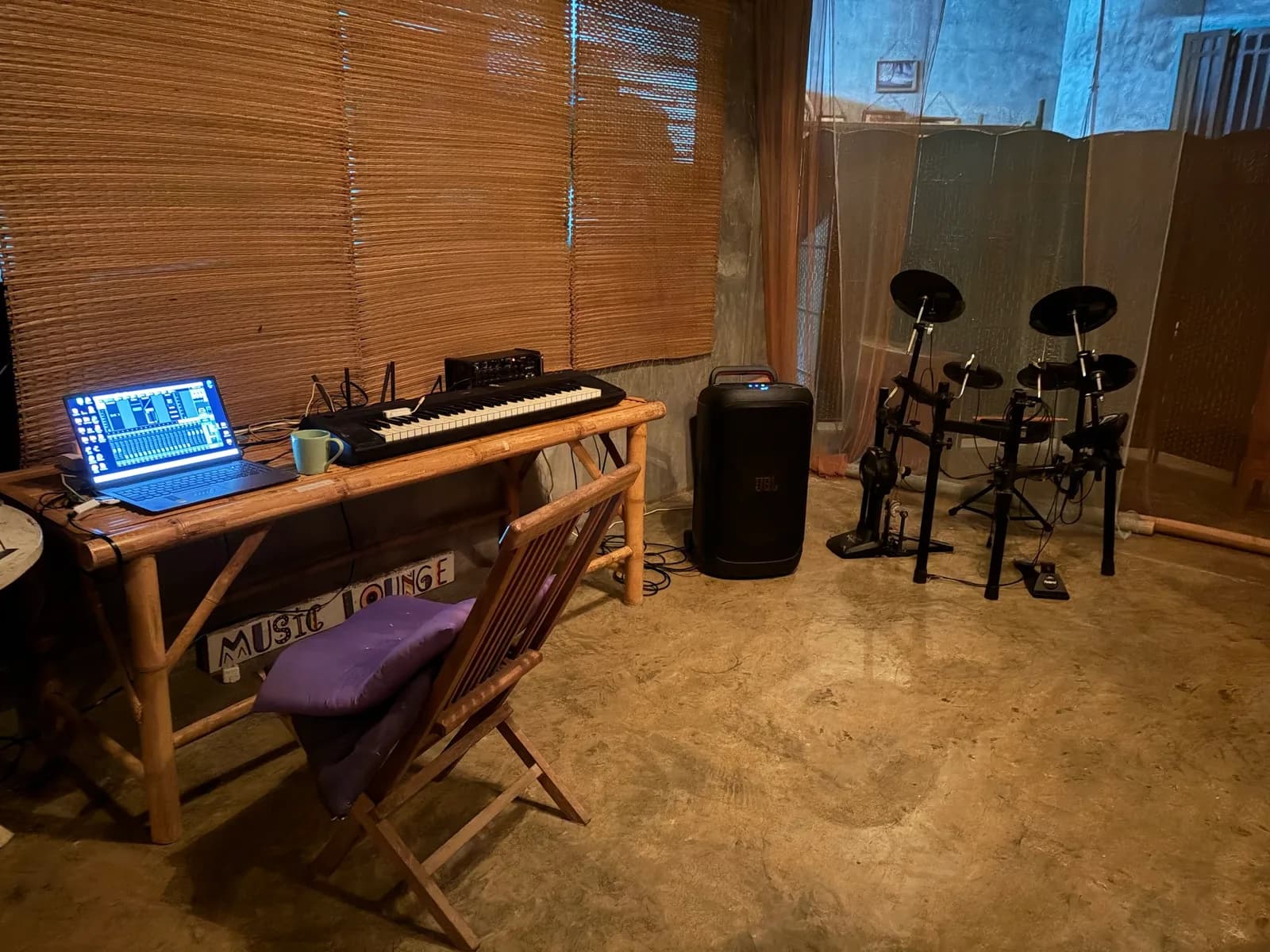 Semi-open-air rehearsal space with electronic drum kit and keyboard on Koh Phangan.